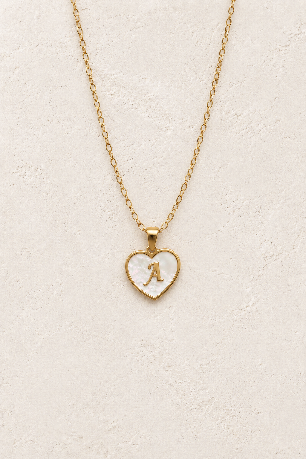 
                  
                    Colette Gold Heart Initial Necklace on cream plaster – Boho & Mala jewellery
                  
                