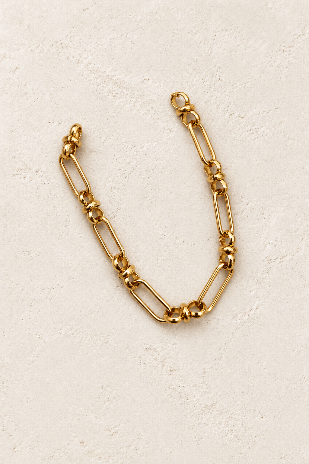 
                  
                    Cosima Gold Mixed Link Bracelet on cream beige textured background
                  
                