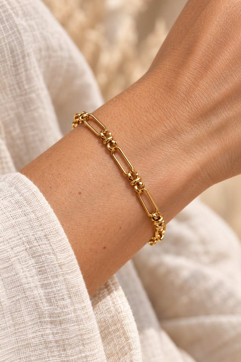 
                  
                    Cosima Gold Mixed Link Bracelet worn on a model's wrist
                  
                
