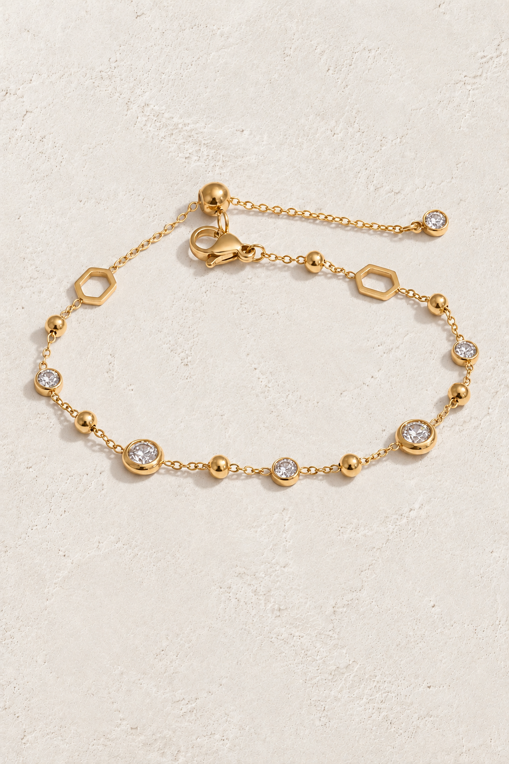 Gold Crystal & Hexagon Bracelet on approved cream hero background