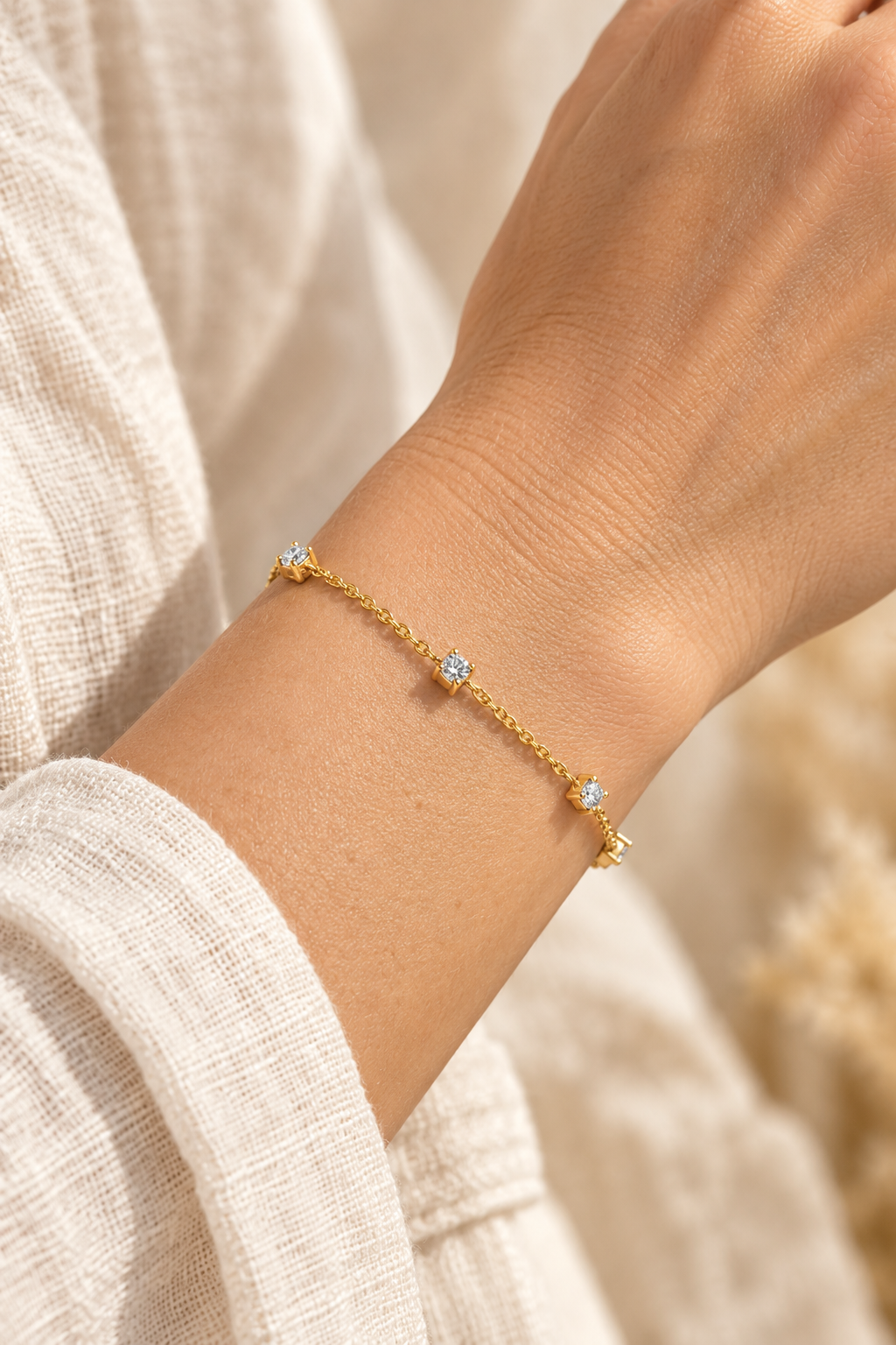 Dainty Crystal Drop Gold Bracelet worn on a model's wrist