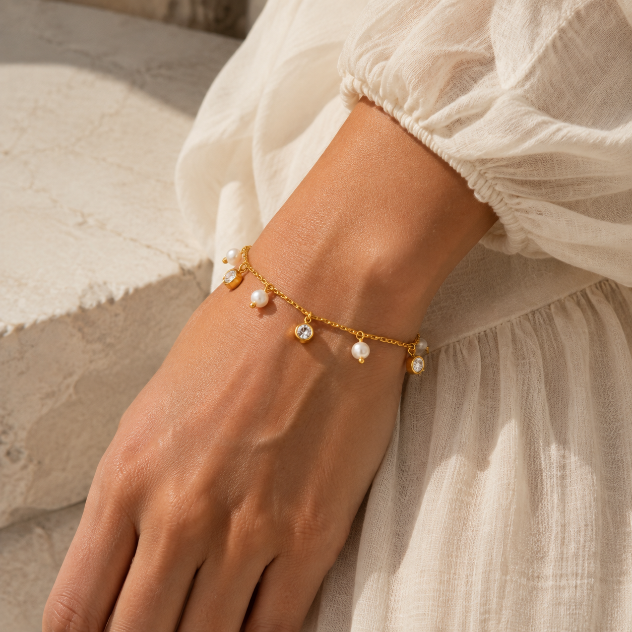 
                  
                    Delphine pearl and crystal drop bracelet worn on boho model
                  
                