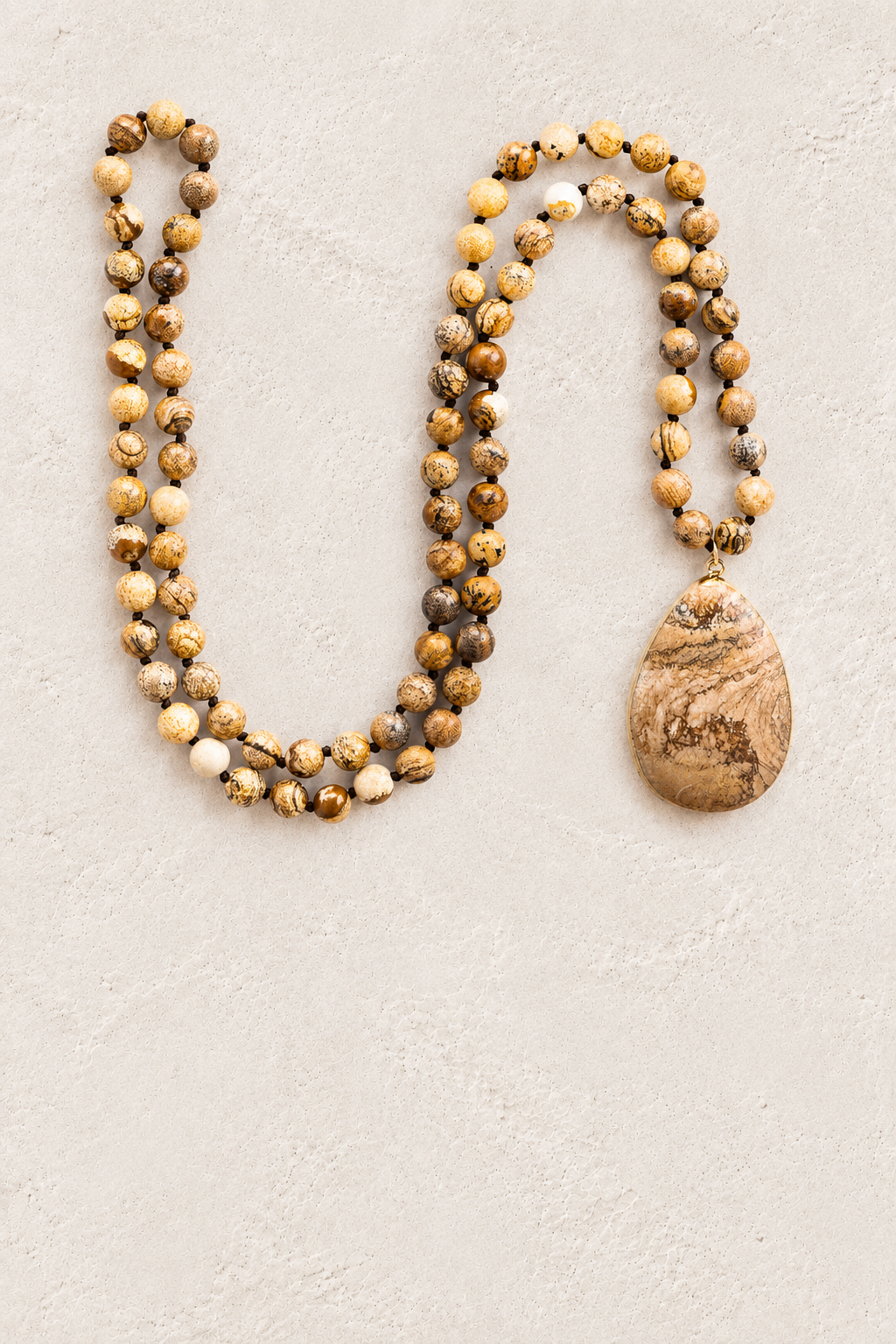 Desert Jasper Tribal Necklace on warm ivory plaster background
