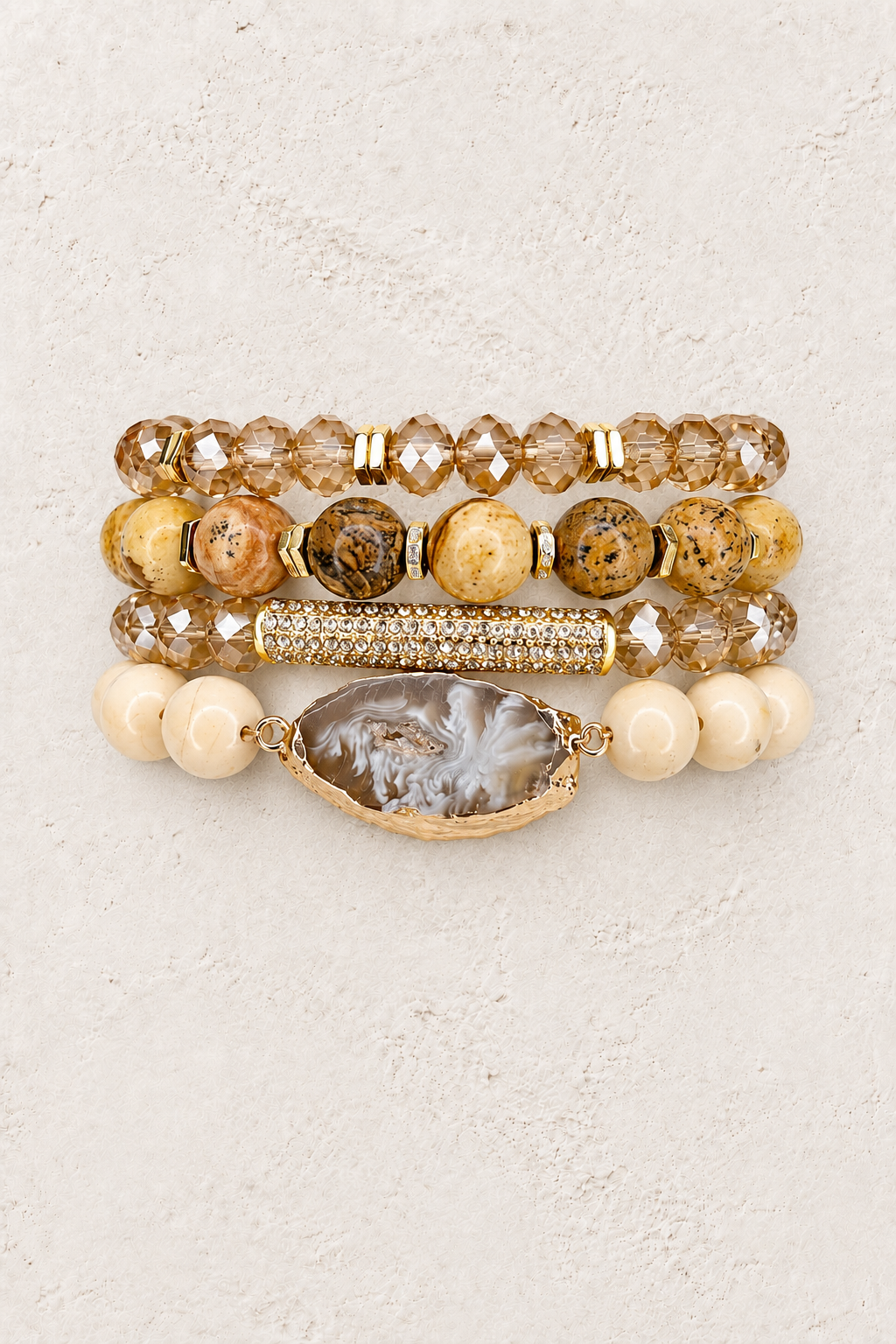 Desert Rose 4-piece elastic bracelet stack on warm textured background