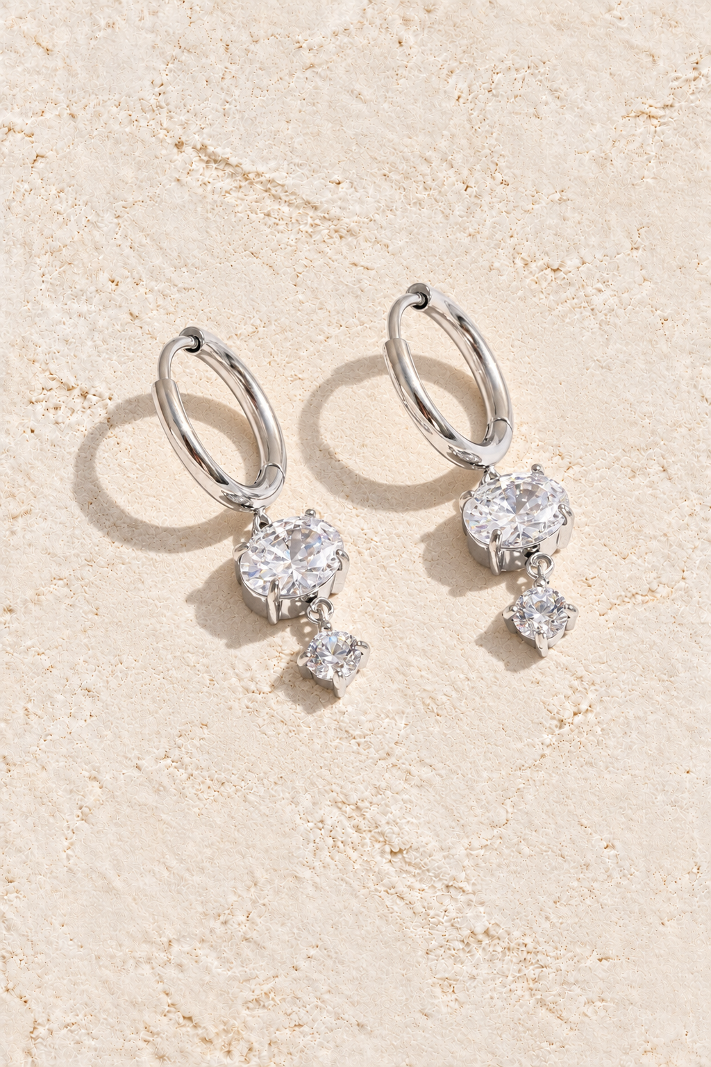 Silver Double Round Crystal Drop Hoop Earrings on cream plaster