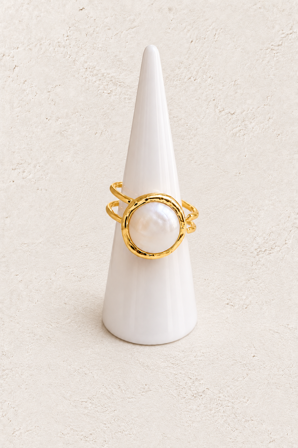 Elara Freshwater Pearl Ring (Adjustable) on white cone against warm textured background