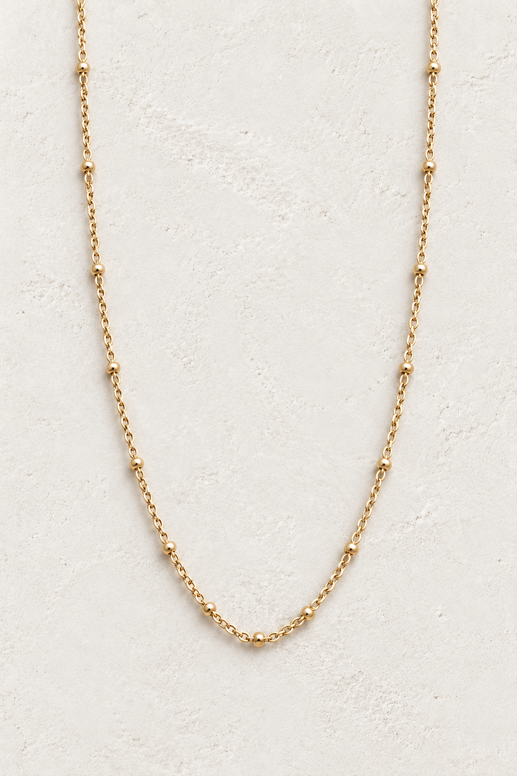 Elaria Gold Chain Necklace TF on the Boho & Mala cream stone hero background