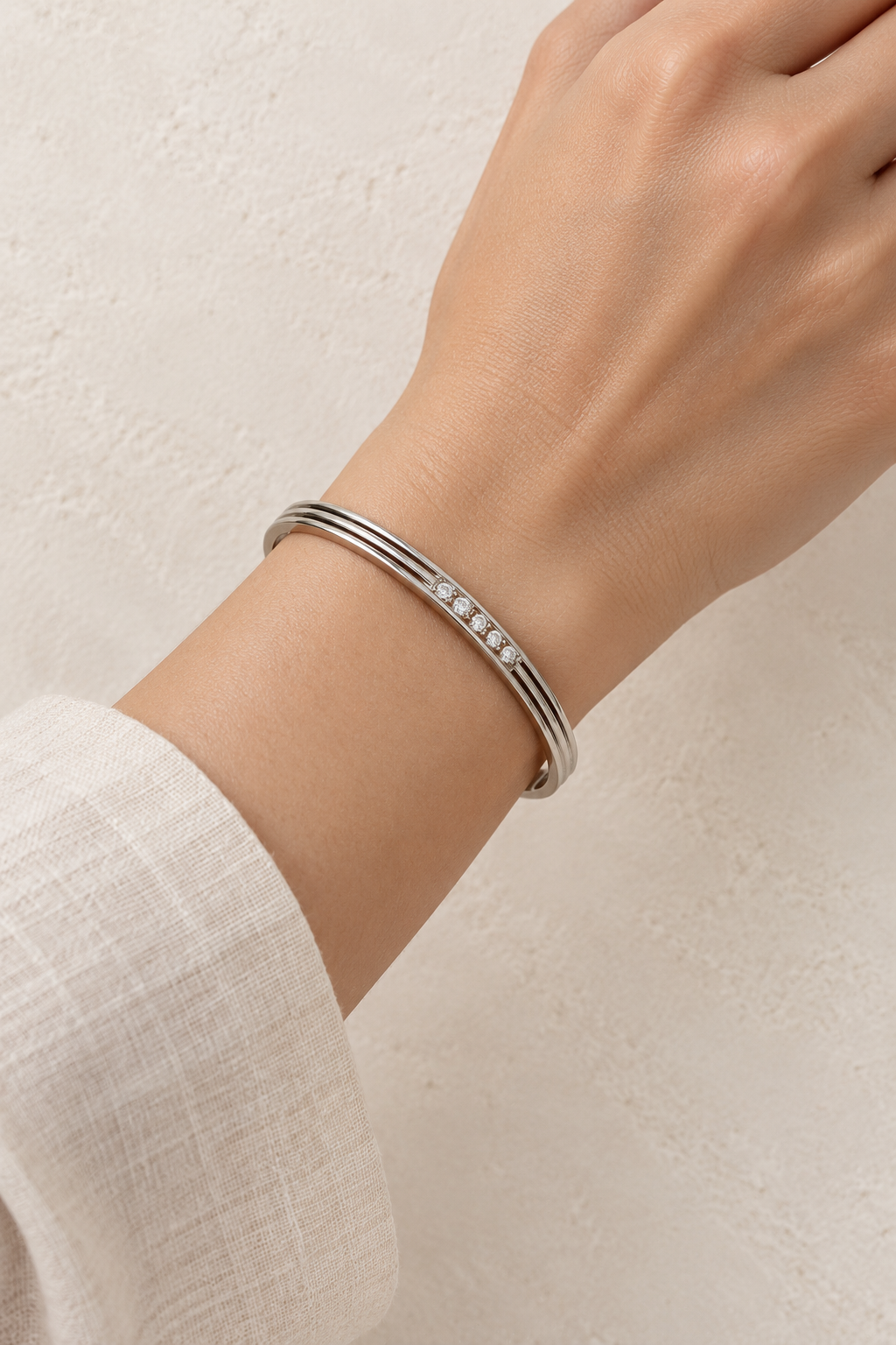 Model wearing Elira Silver Triple Line Crystal Bangle