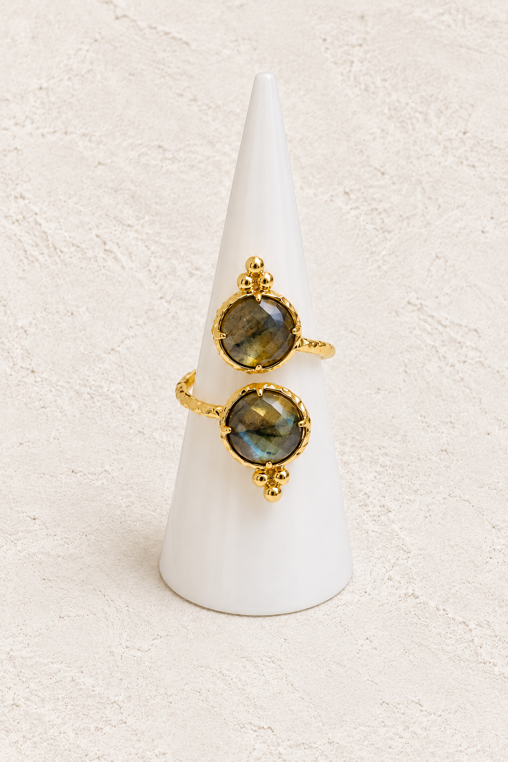 Elowen Labradorite Ring (Adjustable) on white cone against warm textured background