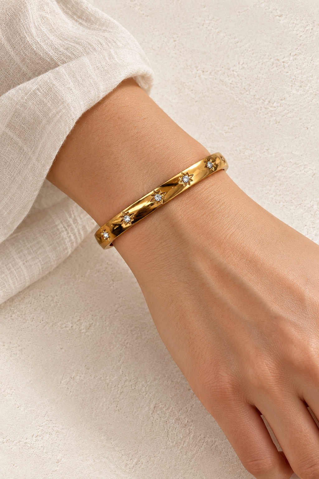 
                  
                    Model wearing Norelle Gold Starlight Bangle
                  
                