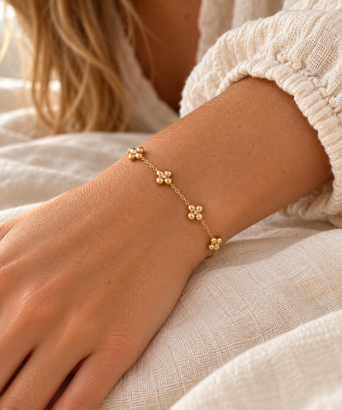Four-Petal Crystal Flower Chain Bracelet – Gold on wrist – AI styling illustration