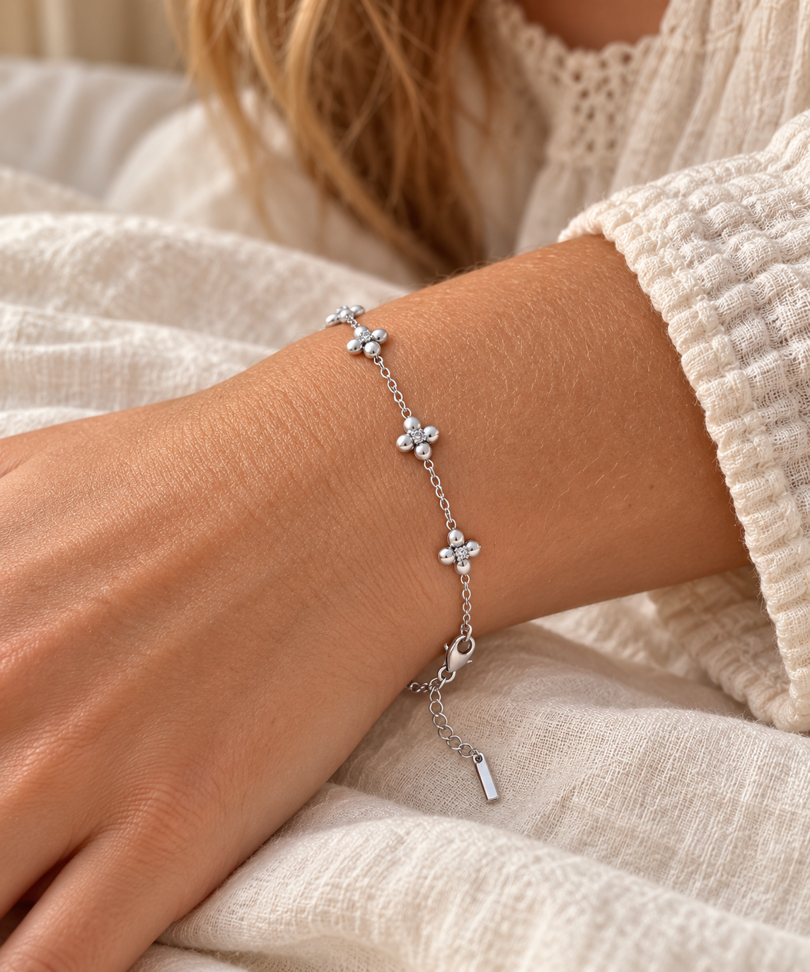 Four-Petal Crystal Flower Chain Bracelet – Silver on wrist – AI styling illustration
