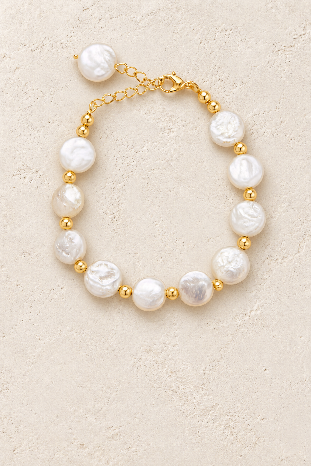 
                  
                    Free Spirit Boho Brass & Gold Natural Pearl Bracelet on cream beige textured background
                  
                