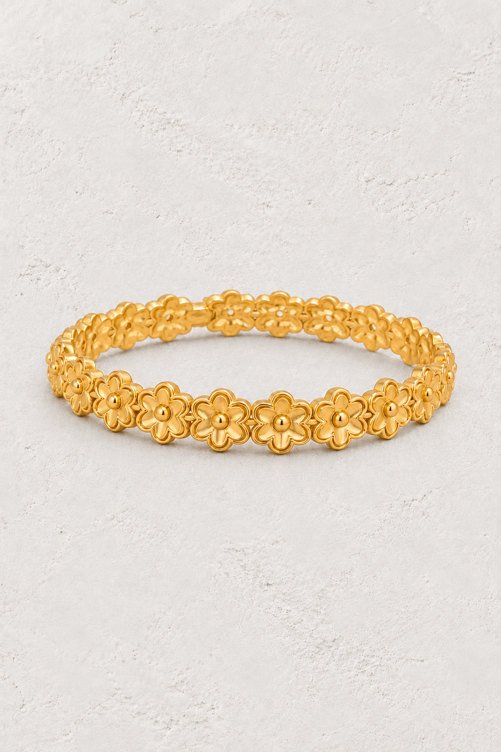 Golden Blossom Floral Link Gold Bracelet on neutral ivory plaster