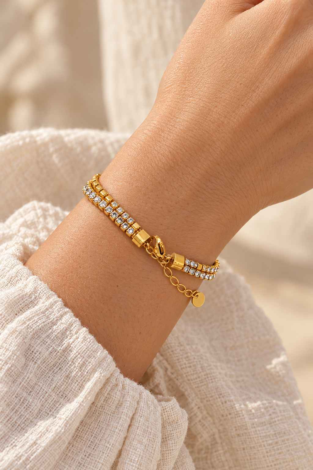 
                  
                    Golden Glow Crystal Layered Bracelet worn on a model's wrist
                  
                
