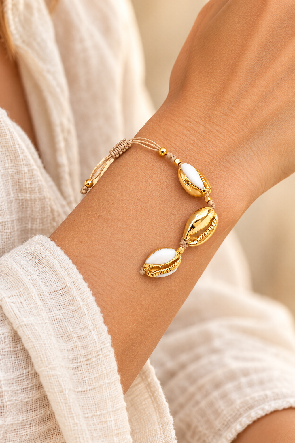 Golden Tide Shell Bracelet worn on a model's wrist
