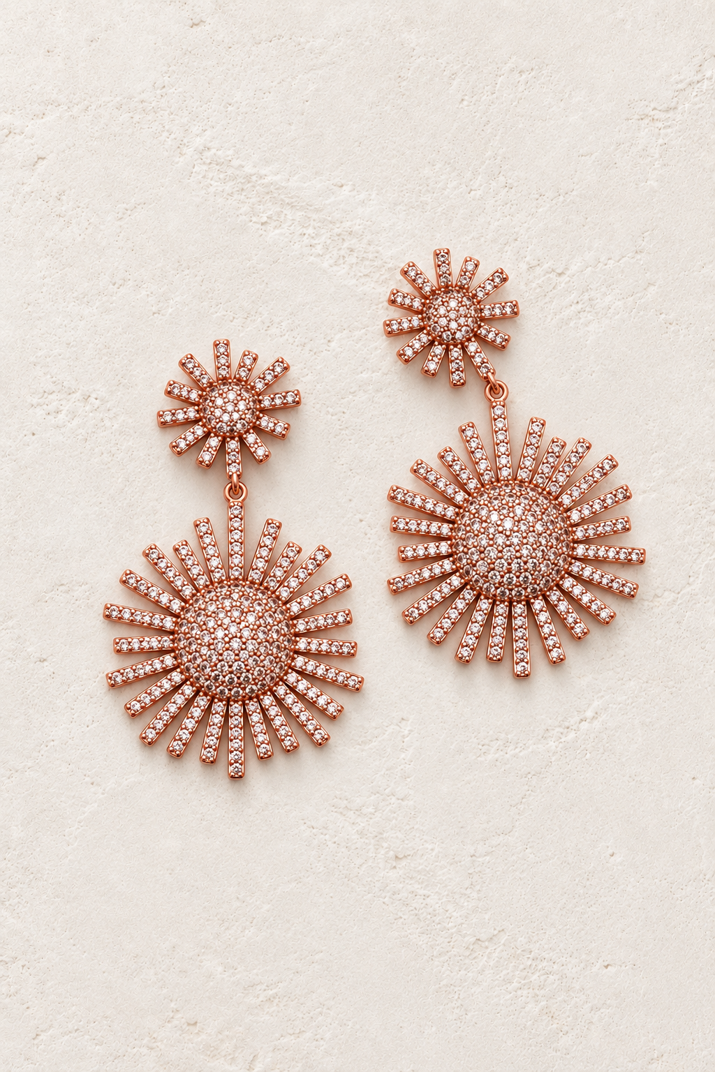 Helia Crystal Sunburst Drop Earrings – Rose Gold on cream textured background