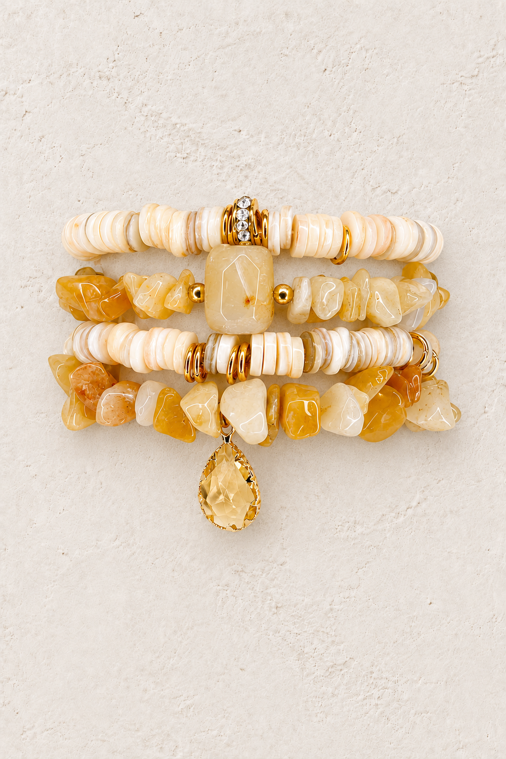 Honey Glow 4-piece elastic bracelet stack on warm textured background