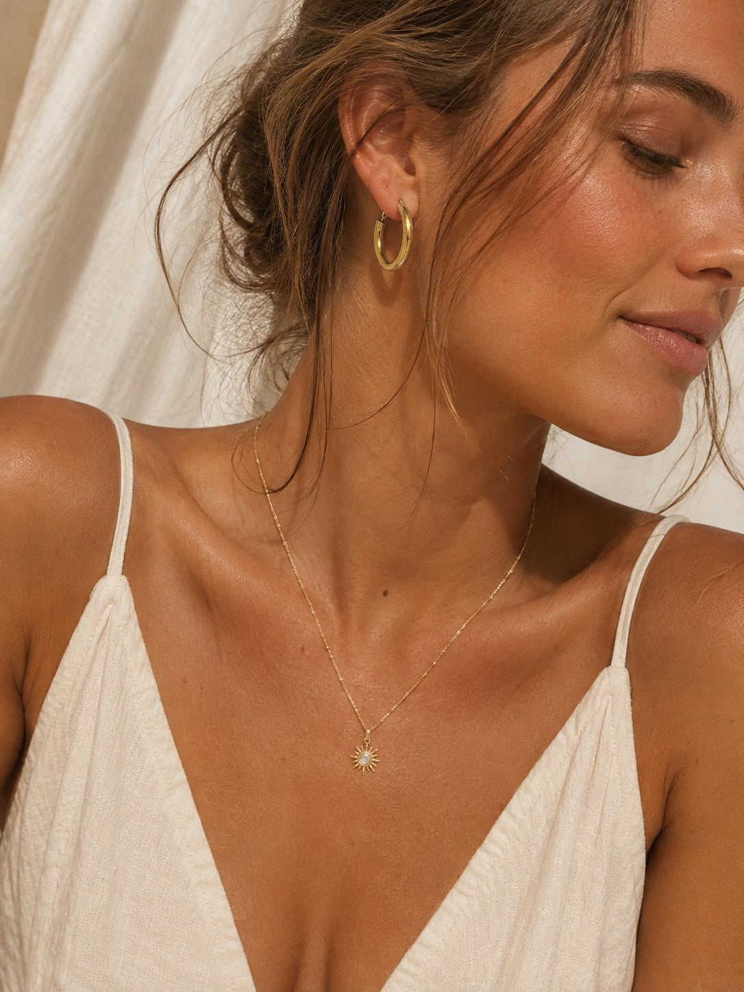 
                  
                    Gold chunky hoop earring styled with gold necklace
                  
                