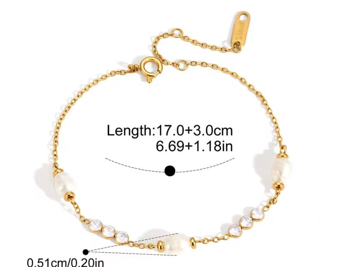 
                  
                    Perla Freshwater Pearl & Crystal Station Bracelet displayed on a white stand
                  
                