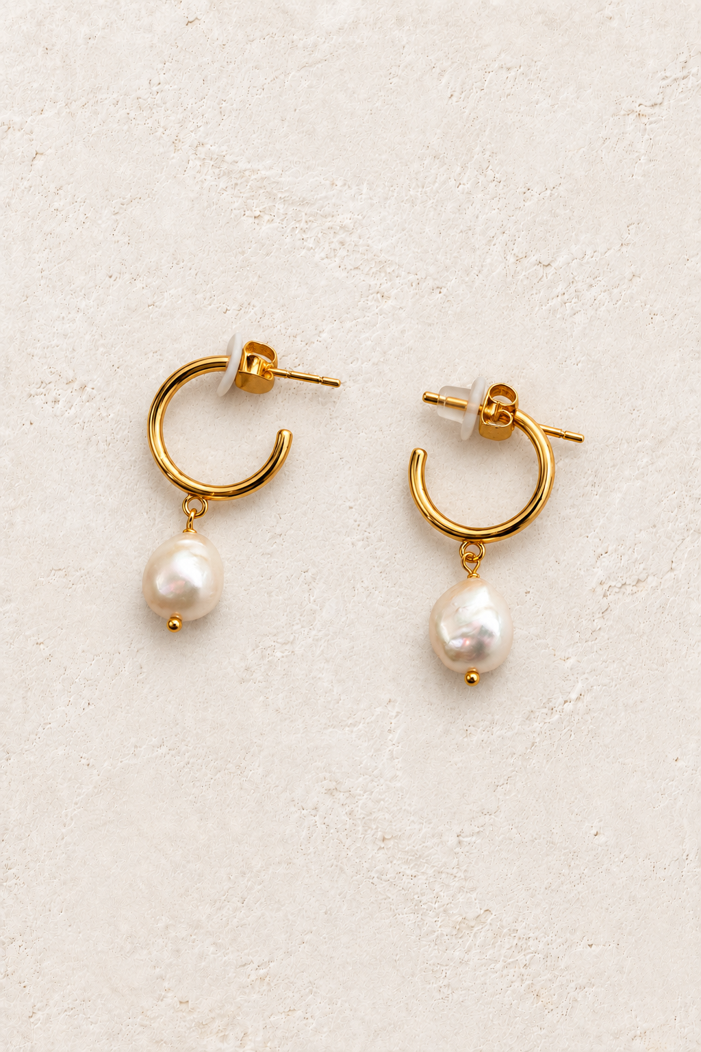 
                  
                    Isla Pearl Drop Hoops on warm ivory textured background
                  
                