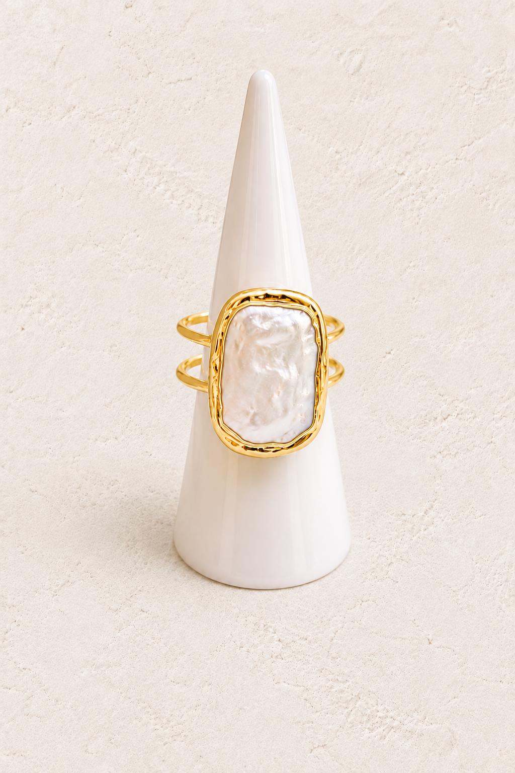 Isolene Freshwater Pearl Ring (Adjustable) on white cone against warm textured background