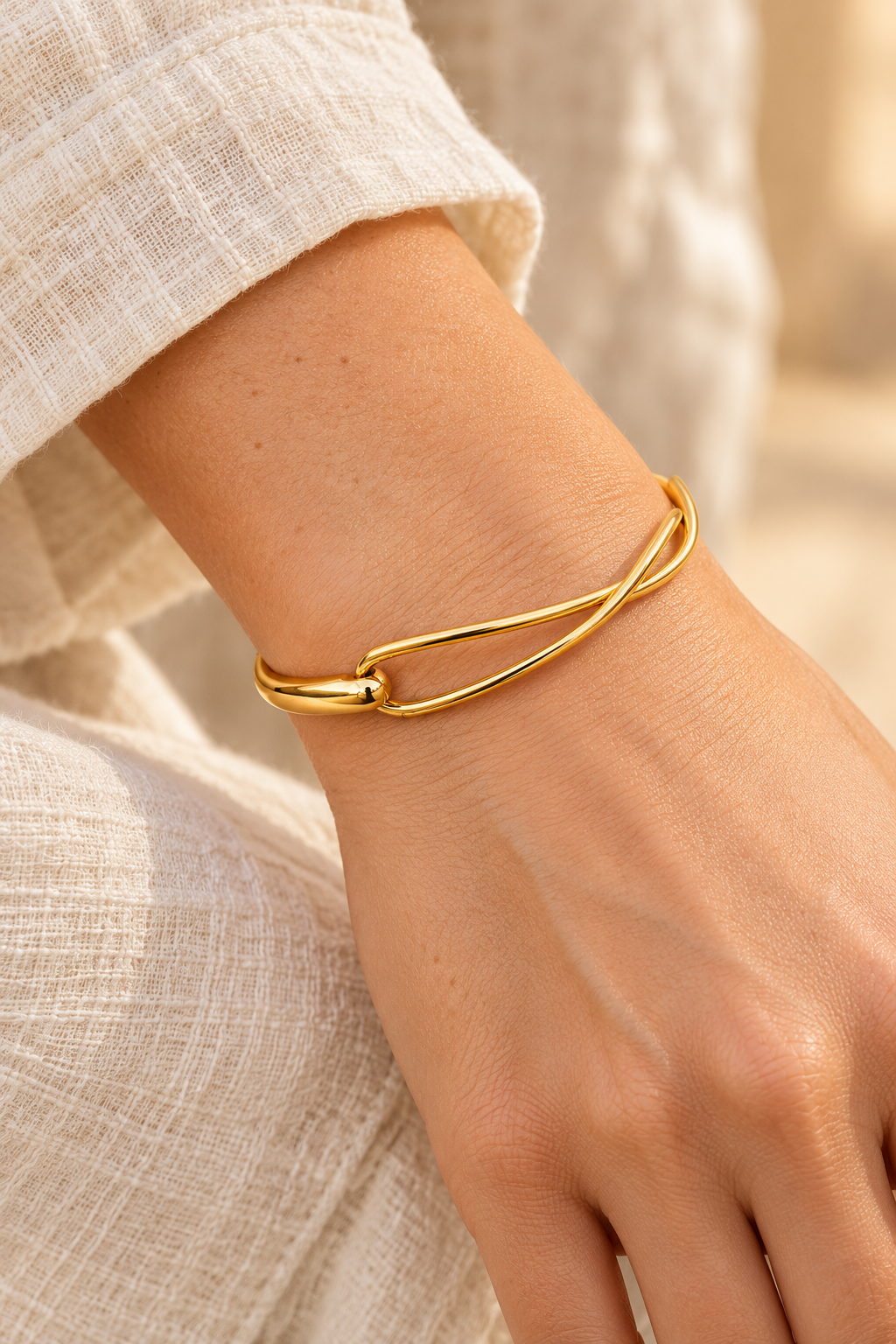 Élanora Gold Intertwined Open Bangle worn on a model's wrist