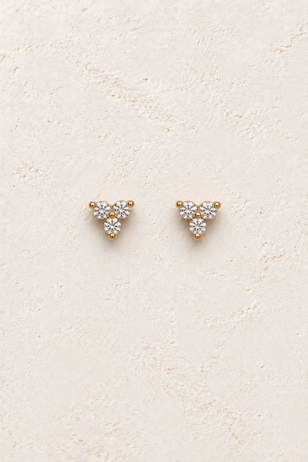 
                  
                    Liora Crystal Trio Studs on warm ivory textured background
                  
                