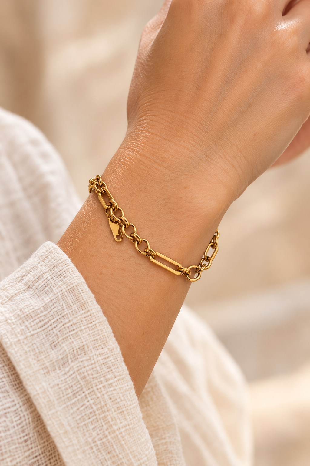 
                  
                    Lisette Gold Mixed Link Bracelet worn on a model's wrist
                  
                