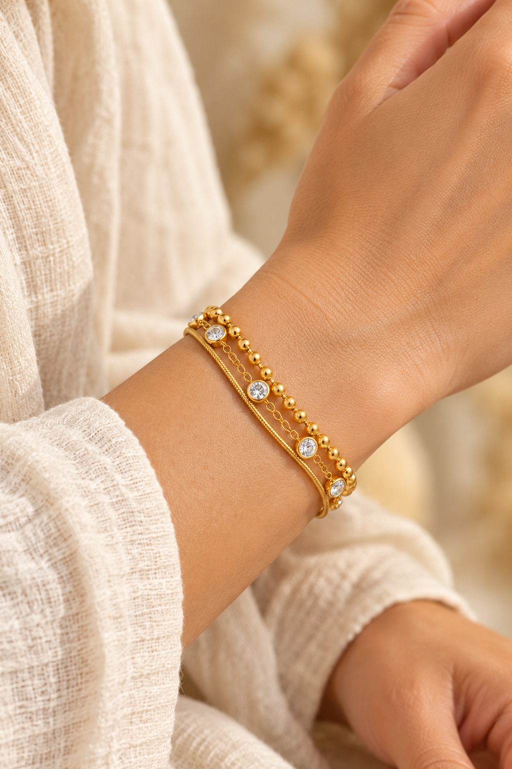 Luna Gold Crystal Layered Bracelet worn on a model's wrist