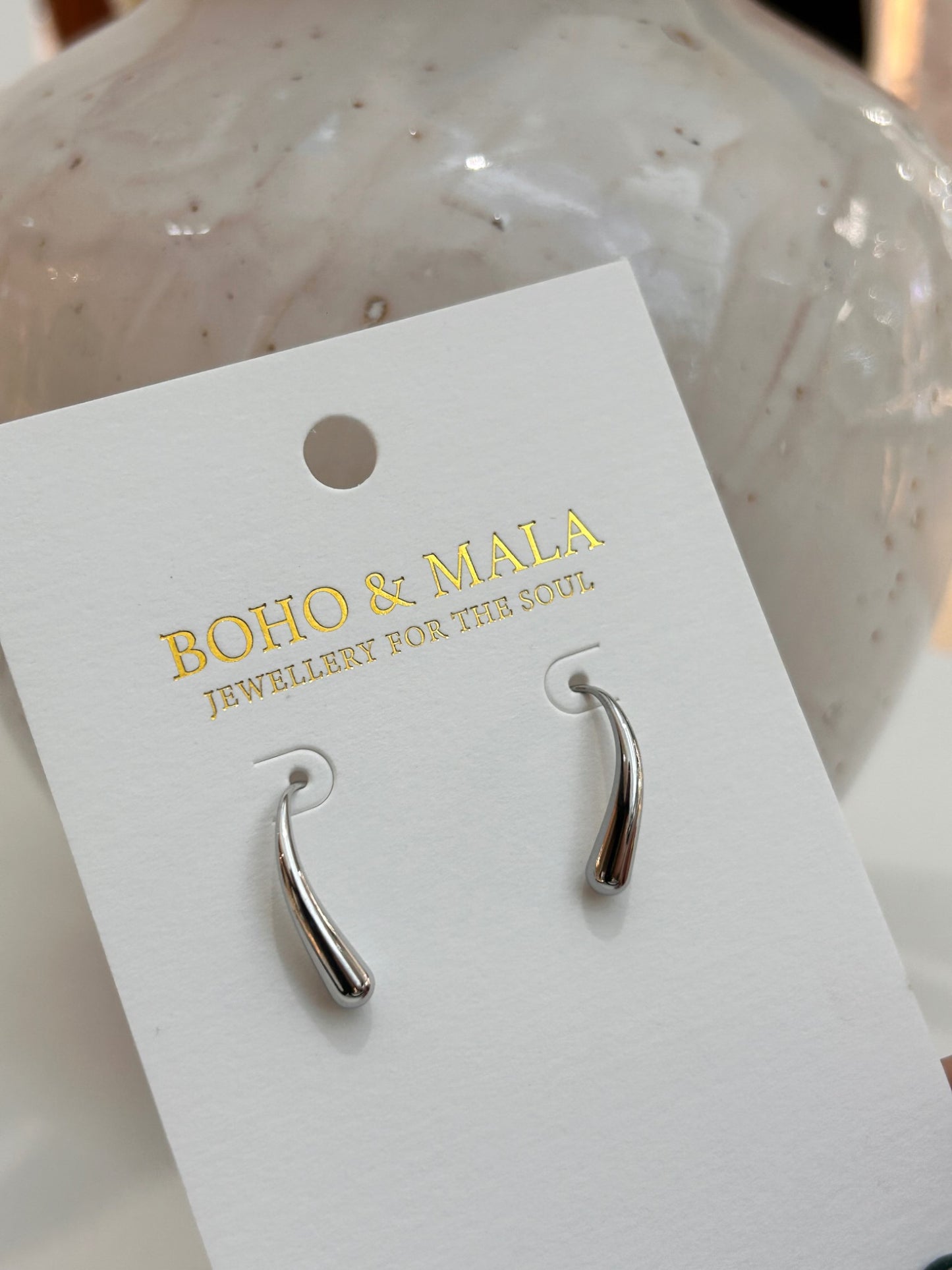 
                  
                    Lune Silver Drop Studs on Boho & Mala display card
                  
                