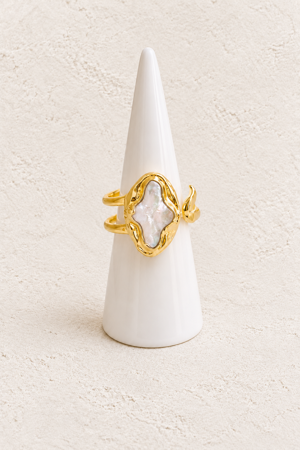 Lunessa Freshwater Pearl Ring (Adjustable) on white cone against warm textured background