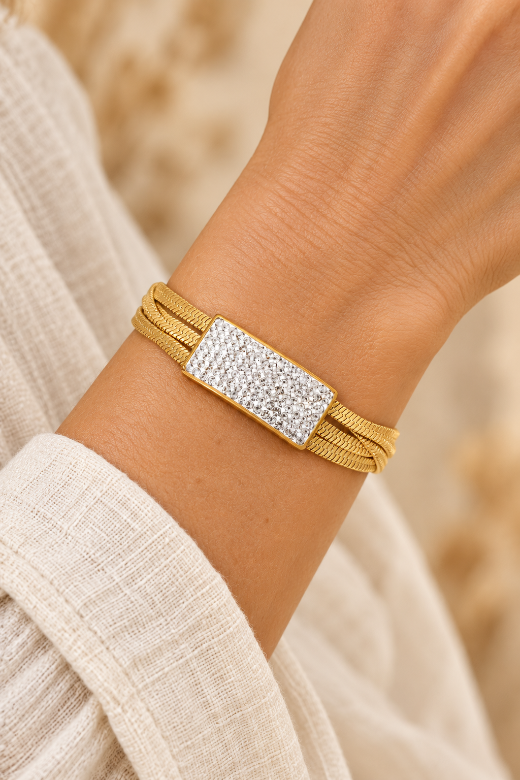 
                  
                    Luxe Pavé Bar Gold Snake Chain Bracelet worn on a model's wrist
                  
                