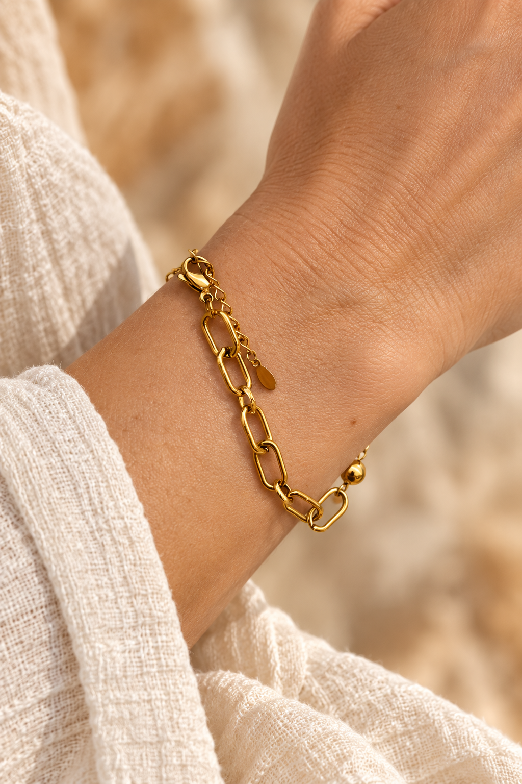 
                  
                    Maelle Gold Bead & Paperclip Bracelet worn on a model's wrist
                  
                