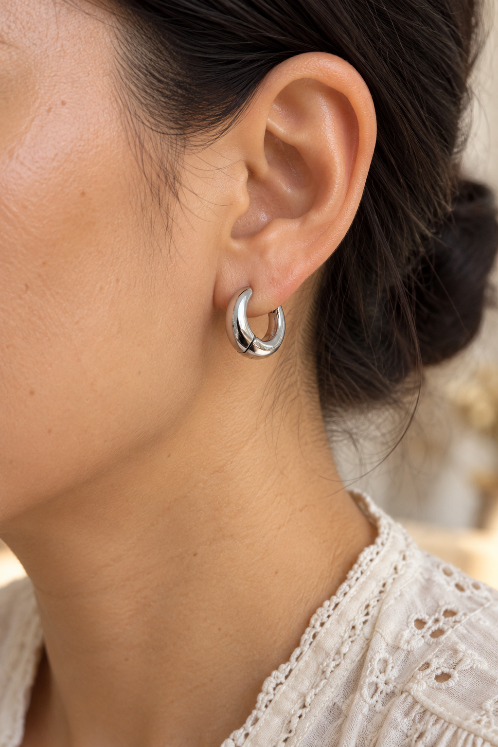 
                  
                    Close-up of Maelle Silver Chunky Hoop Earrings worn on a boho chic model
                  
                