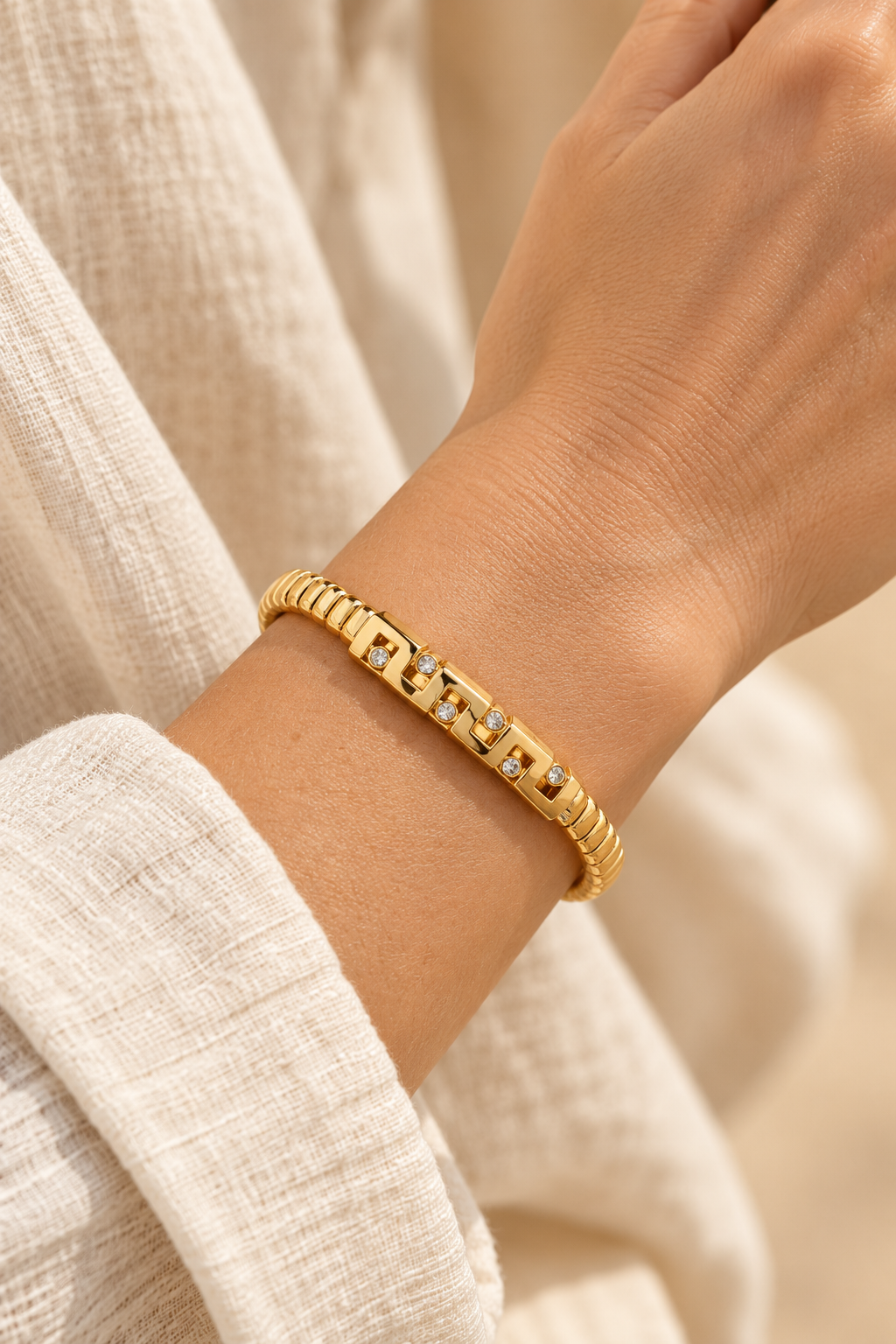Marcella Gold Geometric Crystal Bangle worn on a model's wrist
