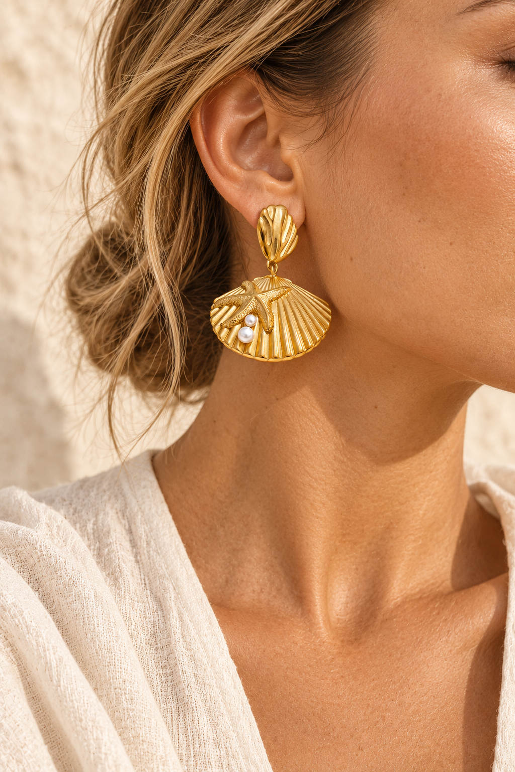 Model wearing Maribel gold shell fan and pearl earring