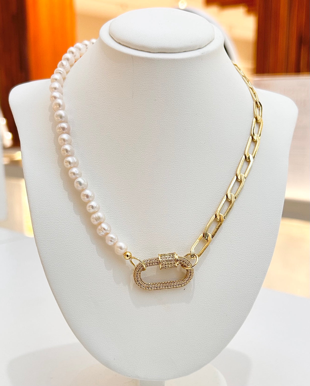 
                  
                    Marielle split freshwater pearl and gold chain necklace displayed on a jewellery bust
                  
                