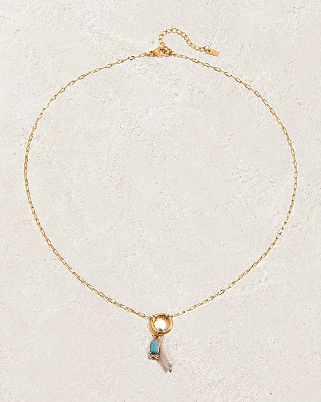
                  
                    Marina Pearl December Turquoise birthstone necklace on cream plaster background
                  
                
