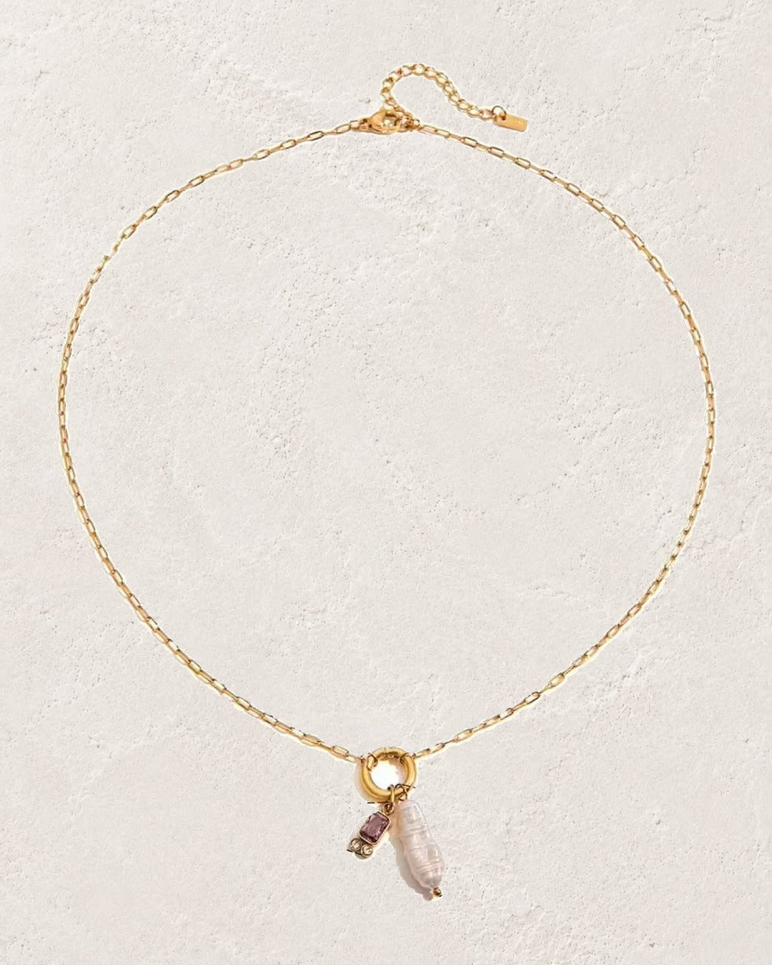 
                  
                    Marina Pearl February Amethyst birthstone necklace on cream plaster background
                  
                