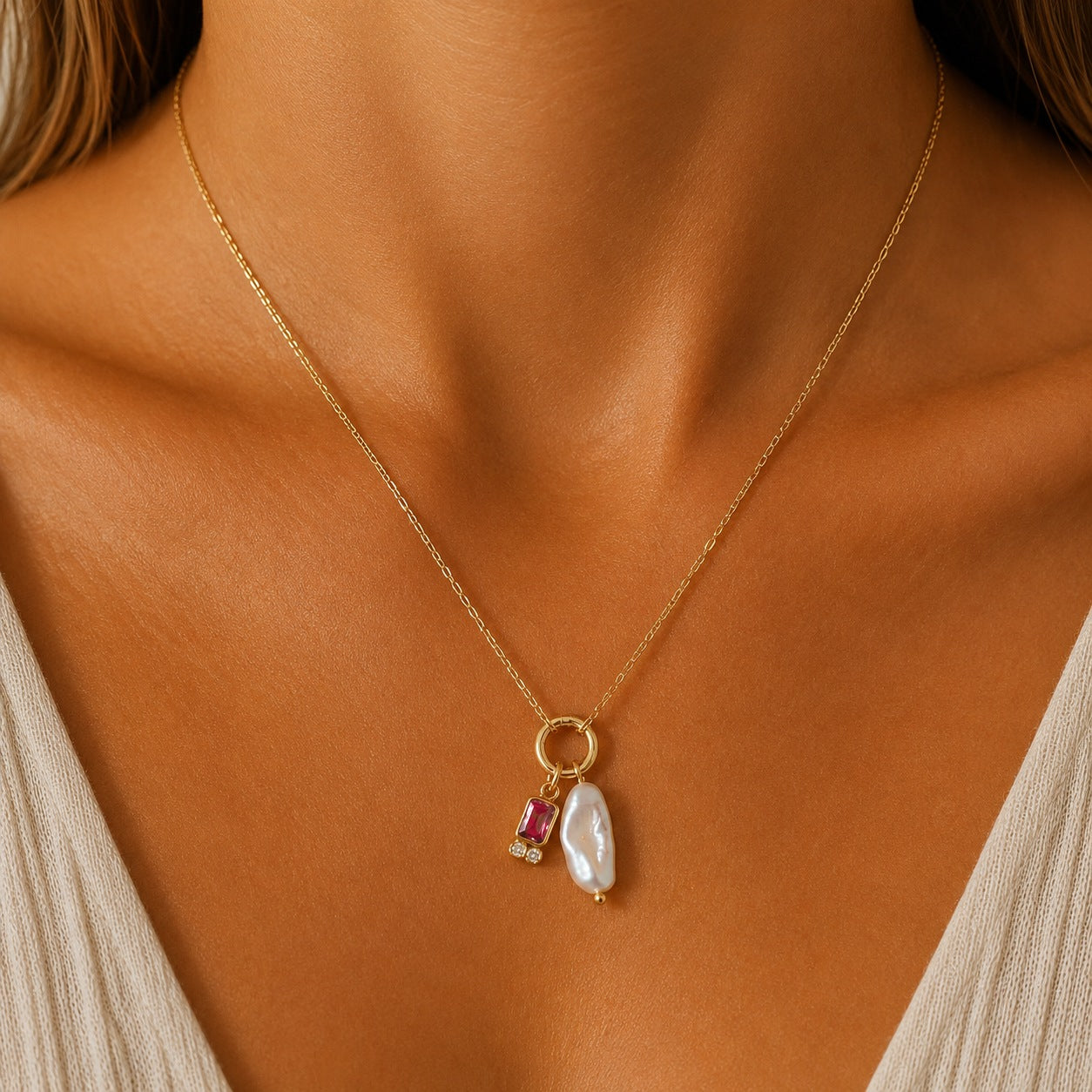 
                  
                    Marina Pearl July Birthstone Necklace - ruby red cubic zirconia, worn on model
                  
                