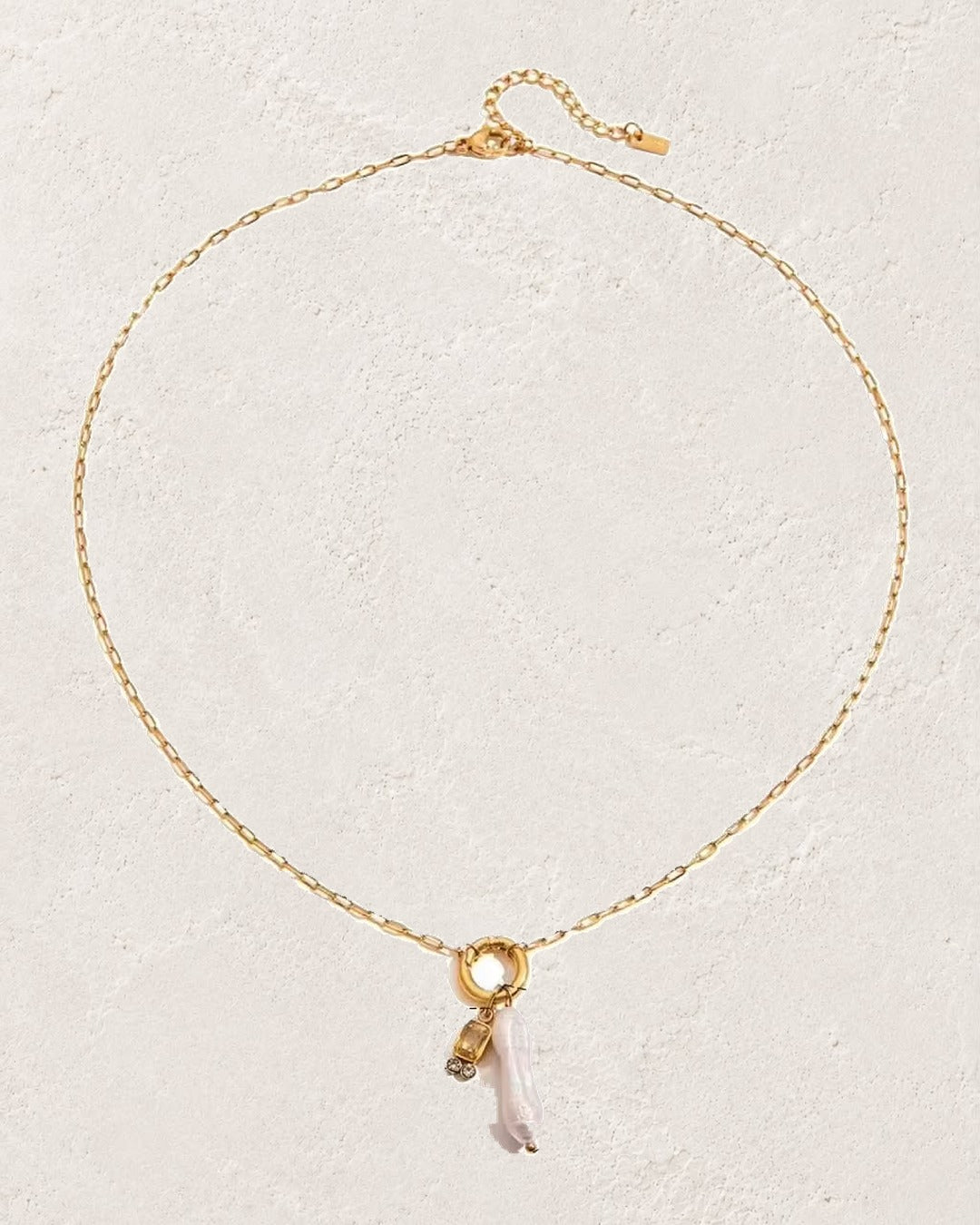 
                  
                    Marina Pearl November Citrine birthstone necklace on cream plaster background
                  
                