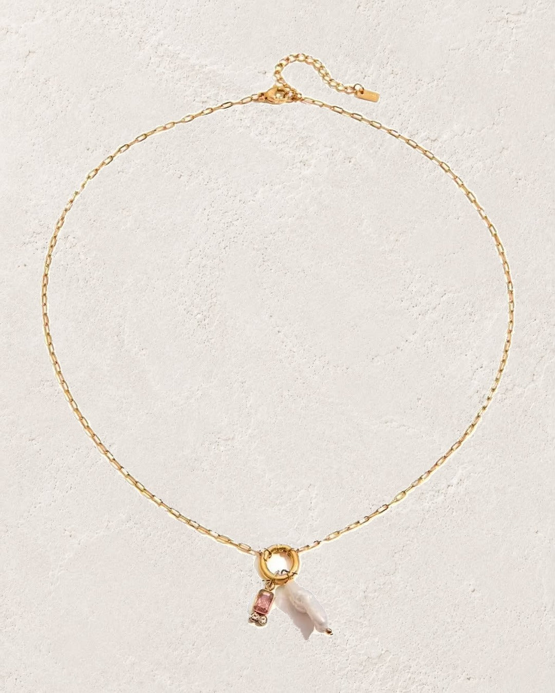 
                  
                    Marina Pearl October Pink Tourmaline birthstone necklace on cream plaster background
                  
                