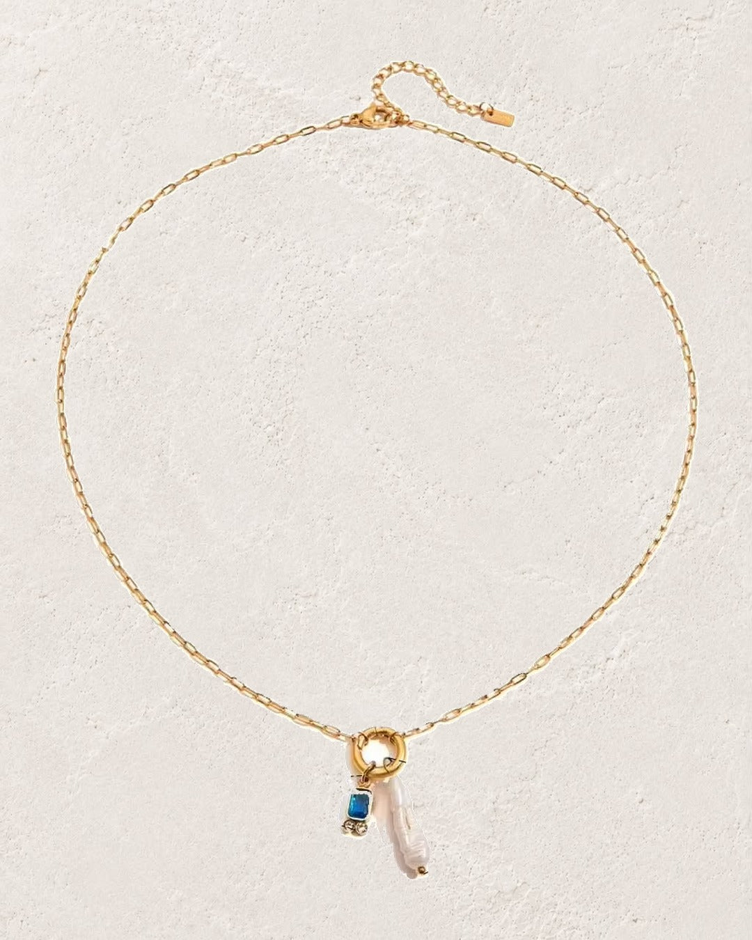
                  
                    Marina Pearl September Sapphire birthstone necklace on cream plaster background
                  
                