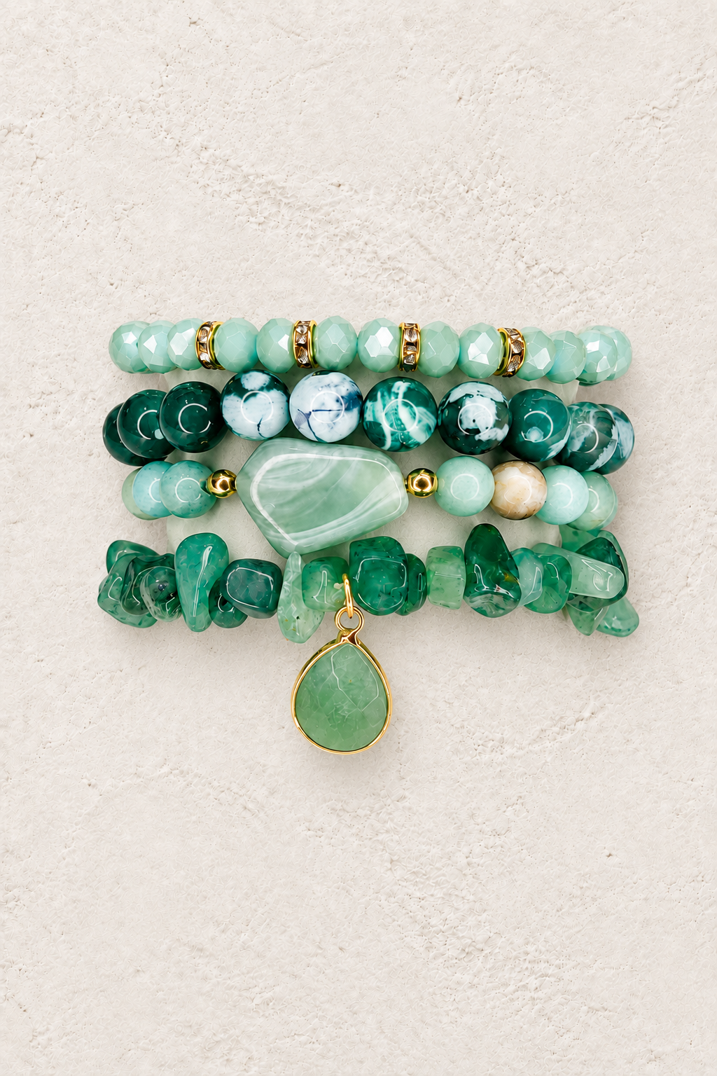 Mint Grove 4-piece elastic bracelet stack on warm textured background