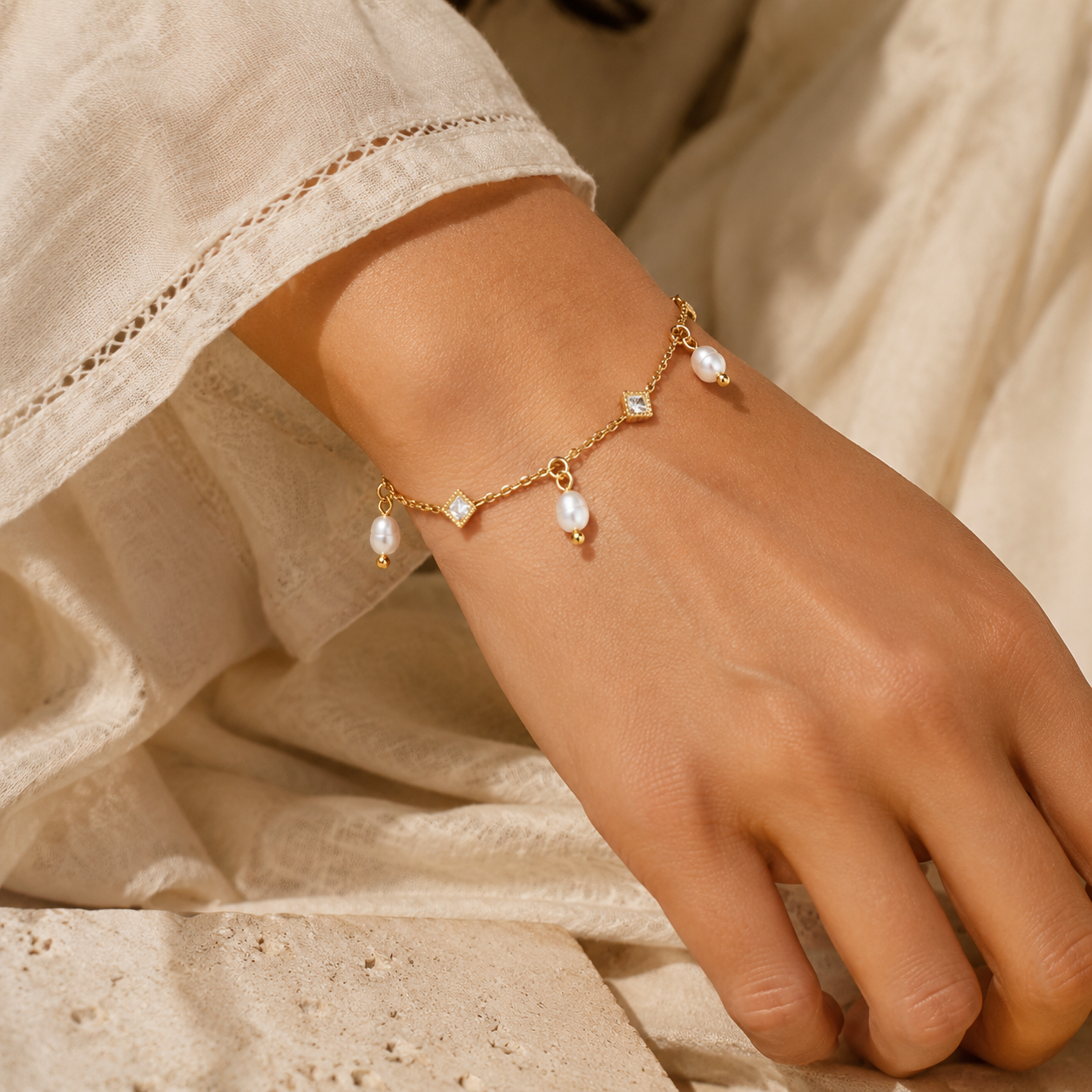 
                  
                    Mira freshwater pearl charm bracelet worn on boho model
                  
                