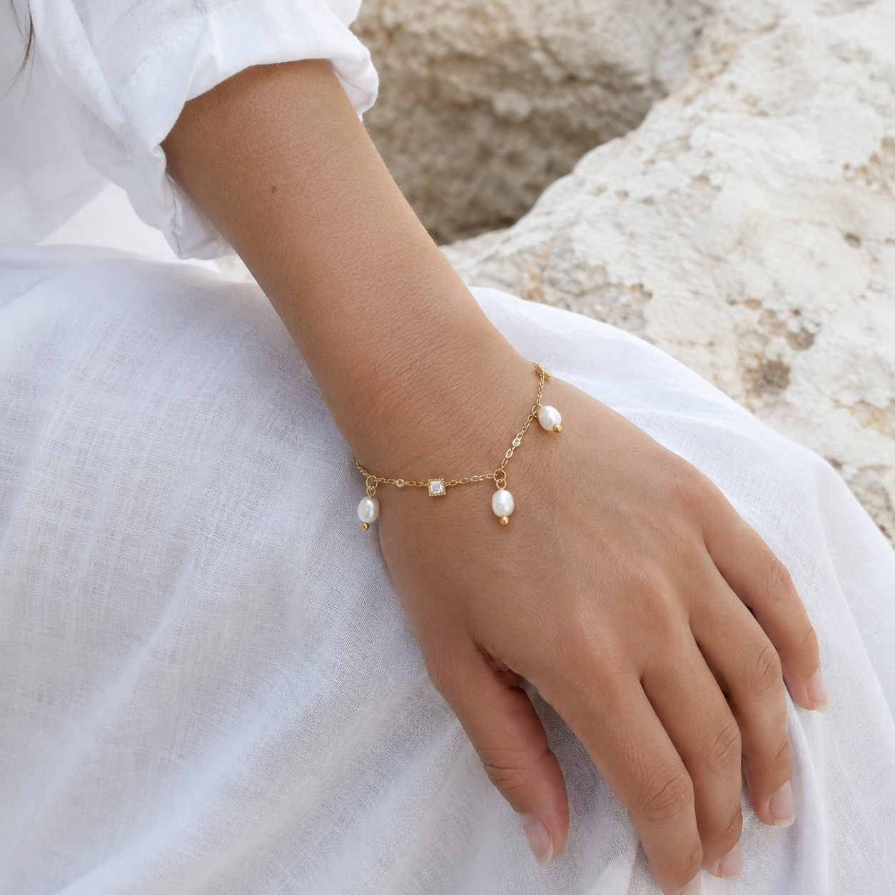 
                  
                    Mira pearl and crystal charm bracelet on boho model
                  
                