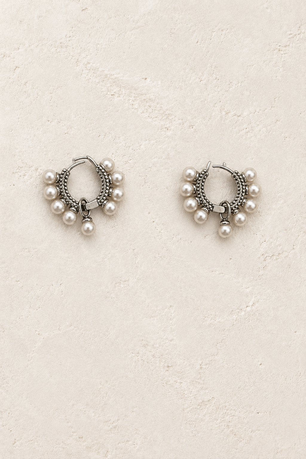 
                  
                    Mirelle Silver Pearl Fringe Hoop Earrings on warm ivory plaster
                  
                