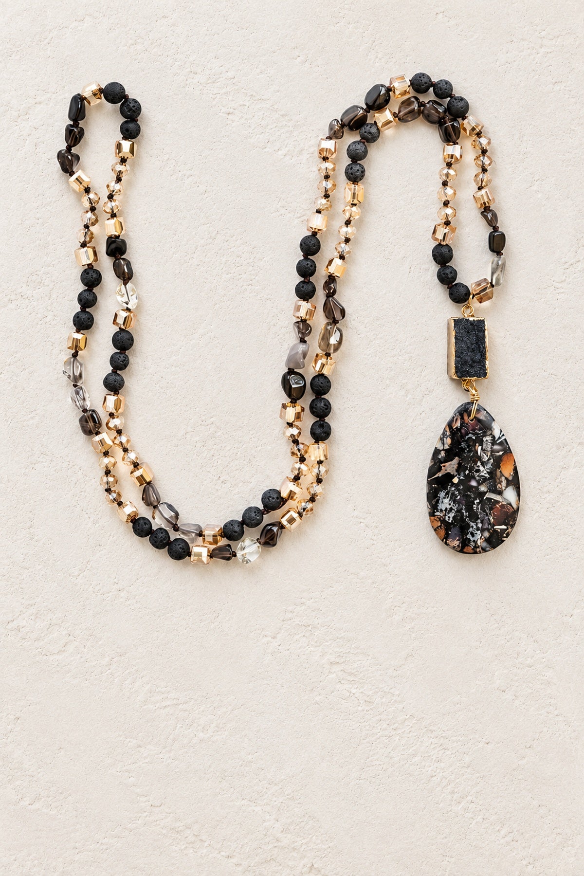 Mixed Agate Tribal Necklace on warm cream plaster background