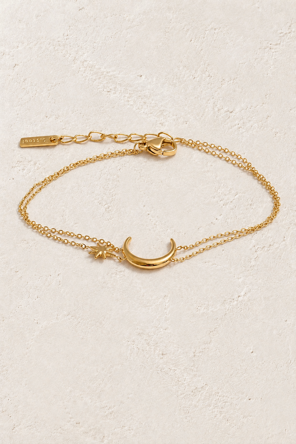 Gold Moon & Star Double Chain Bracelet on approved cream hero background
